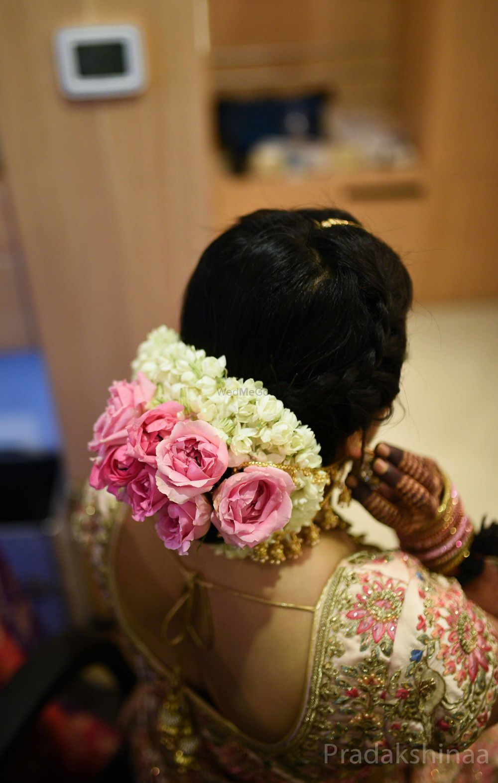 Photo of Bridal bun with roses and mogra