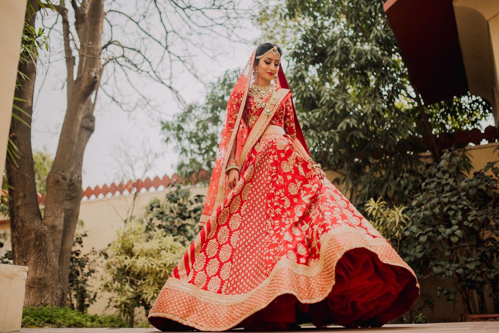 Photo of A twirling bride in red
