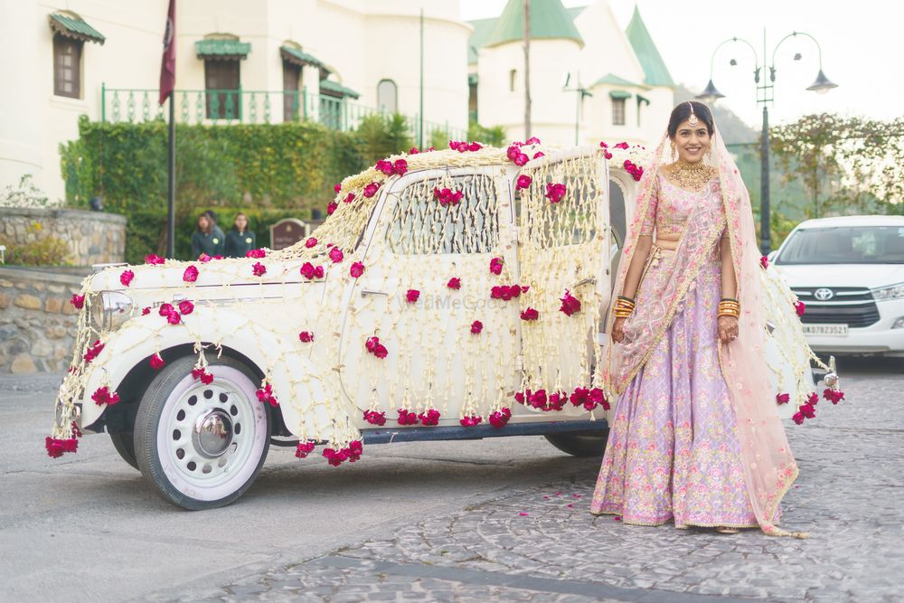 Photo of Bride with decorated car