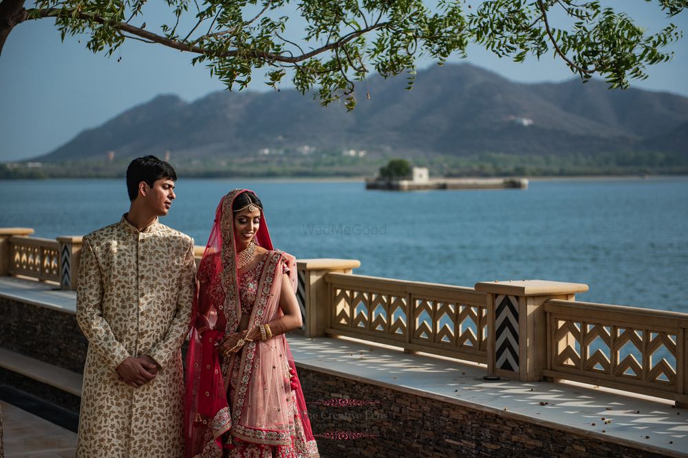 Photo of A couple stands infront of a lake