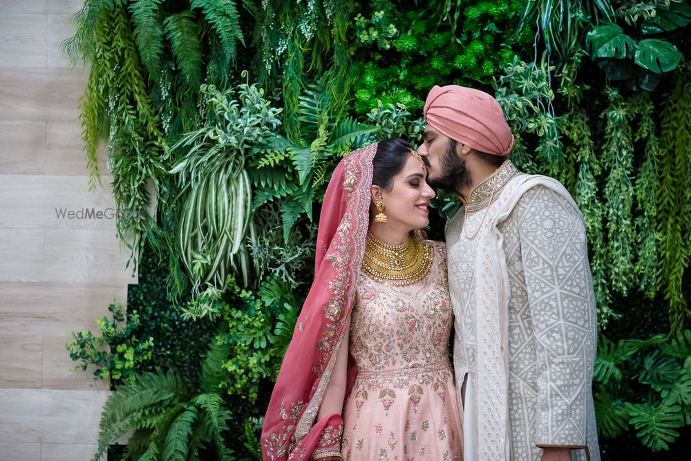 Photo of Groom kissing his bride