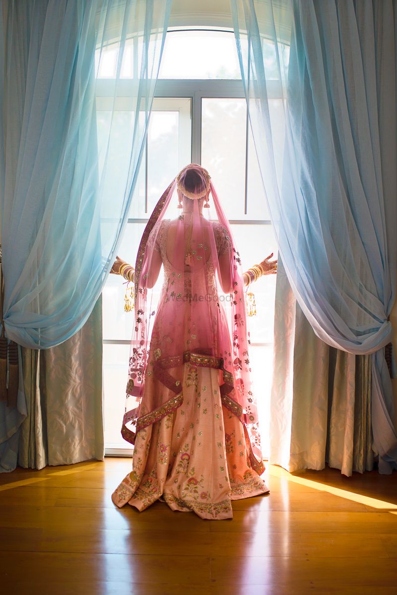 Photo of Bride looks out of a window