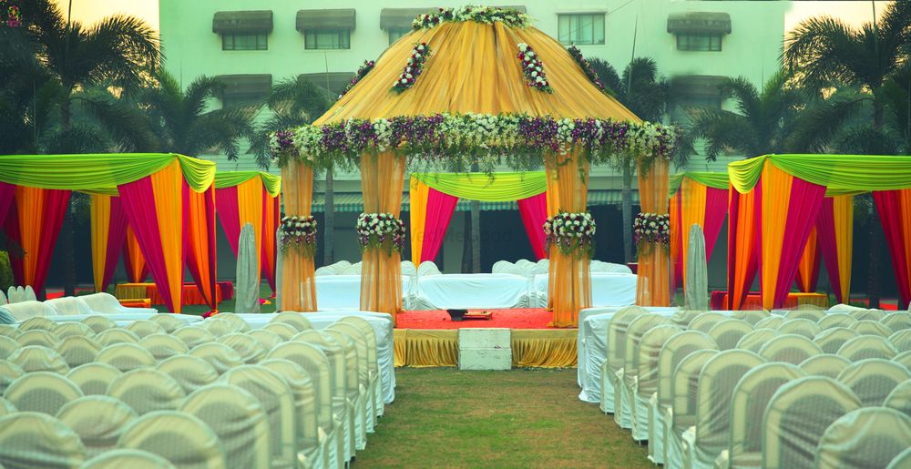 Photo of Yellow Mandap with Red and Yellow Tents
