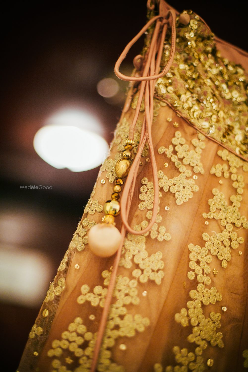 Photo of White Threadwork with Sequins and Pink Pom Poms