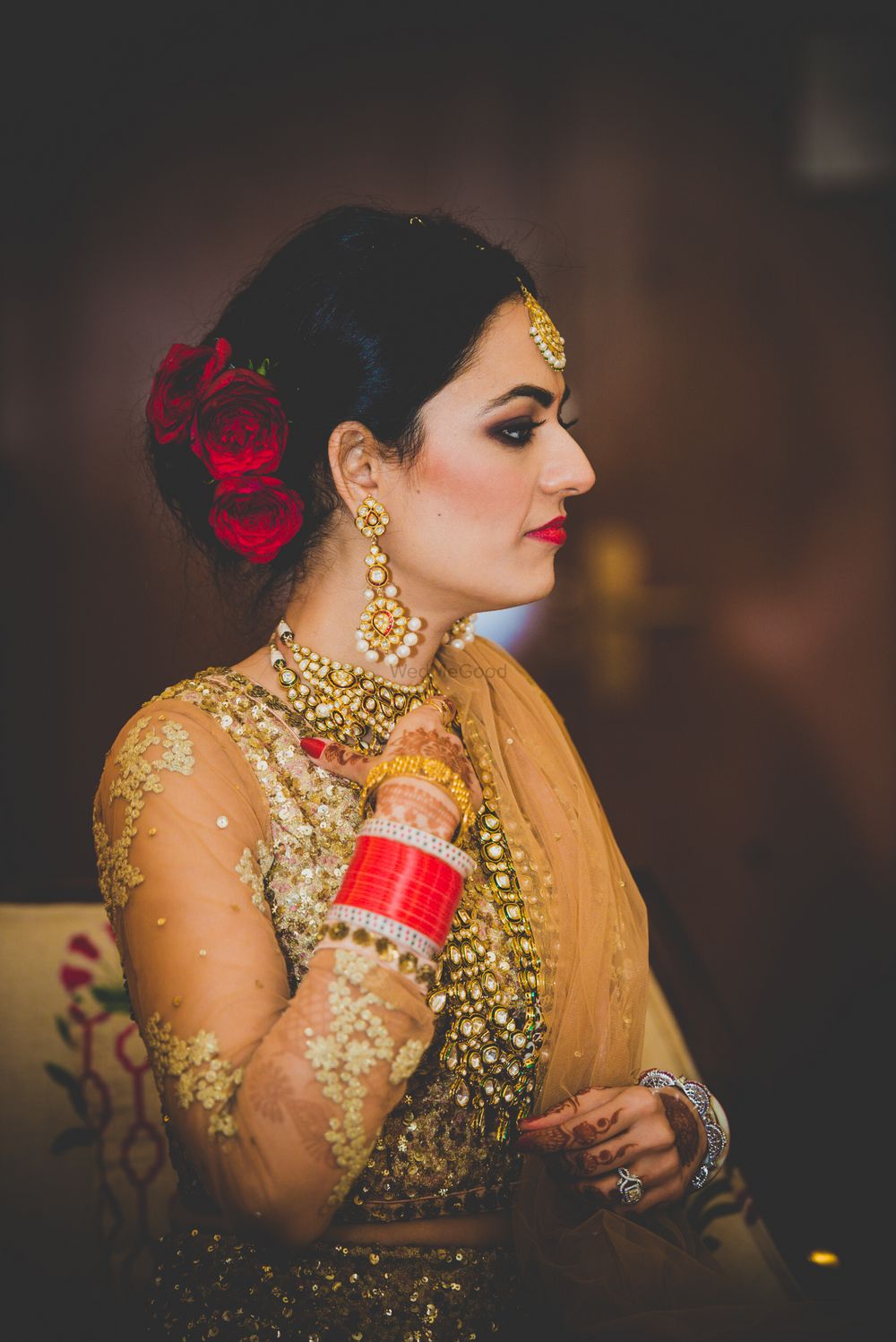Photo of Bride Wearing Red Flowers on Hair