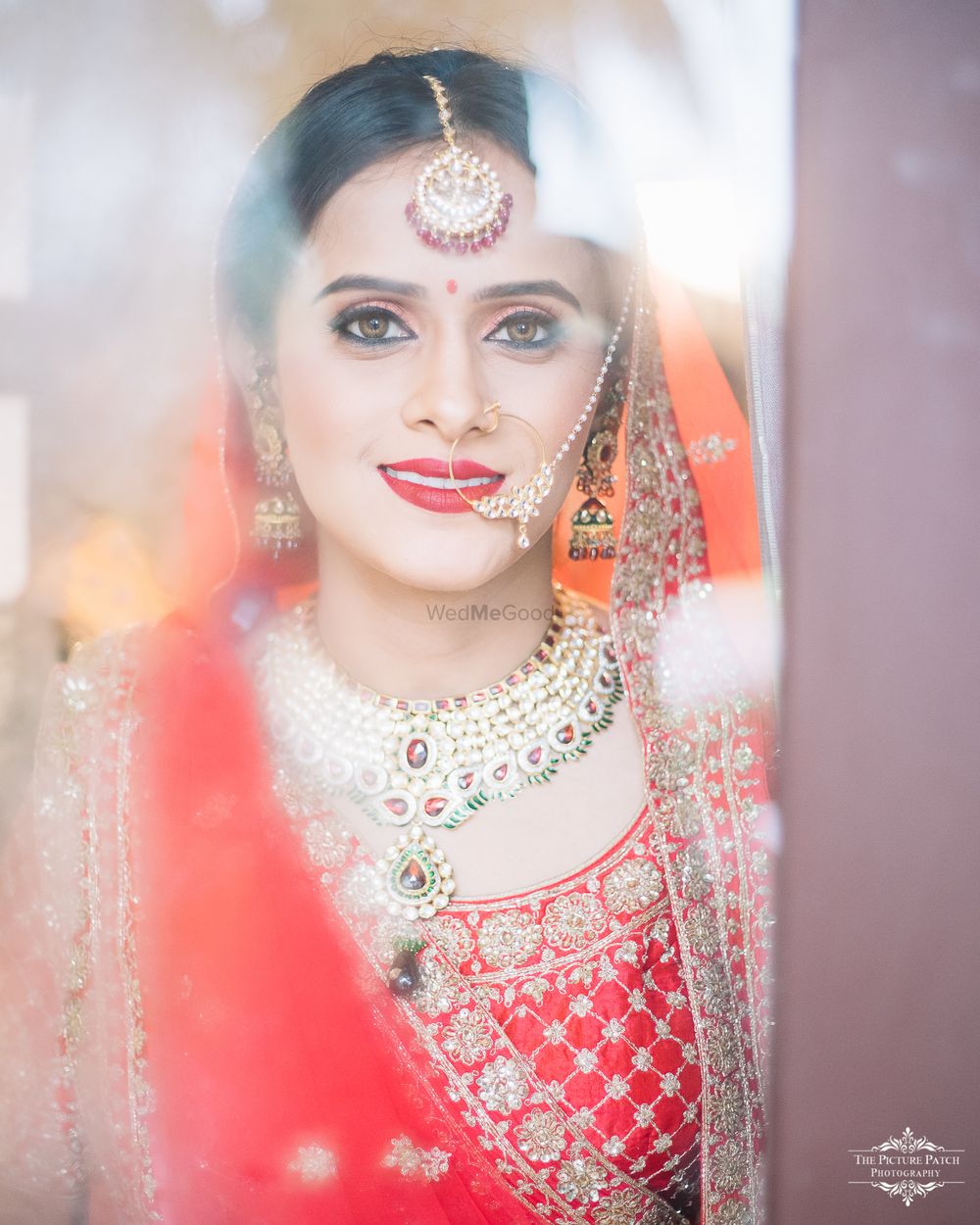 Photo of Reflection bridal portrait wth orange dupatta