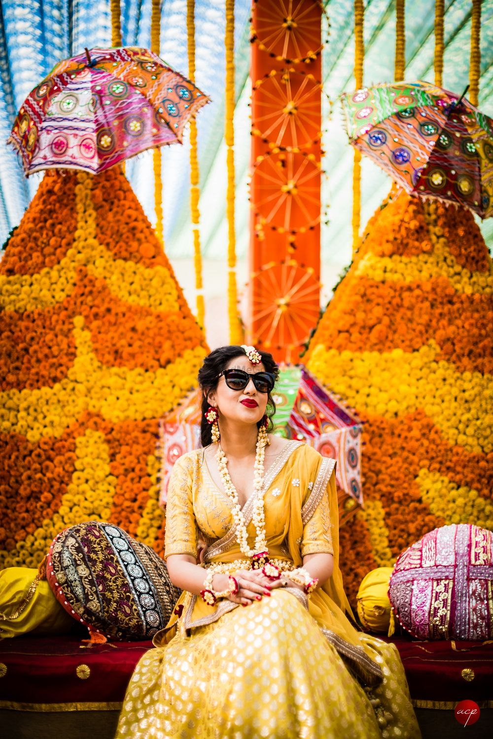 Photo of Happy bride shot in yellow lehenga on mehendi
