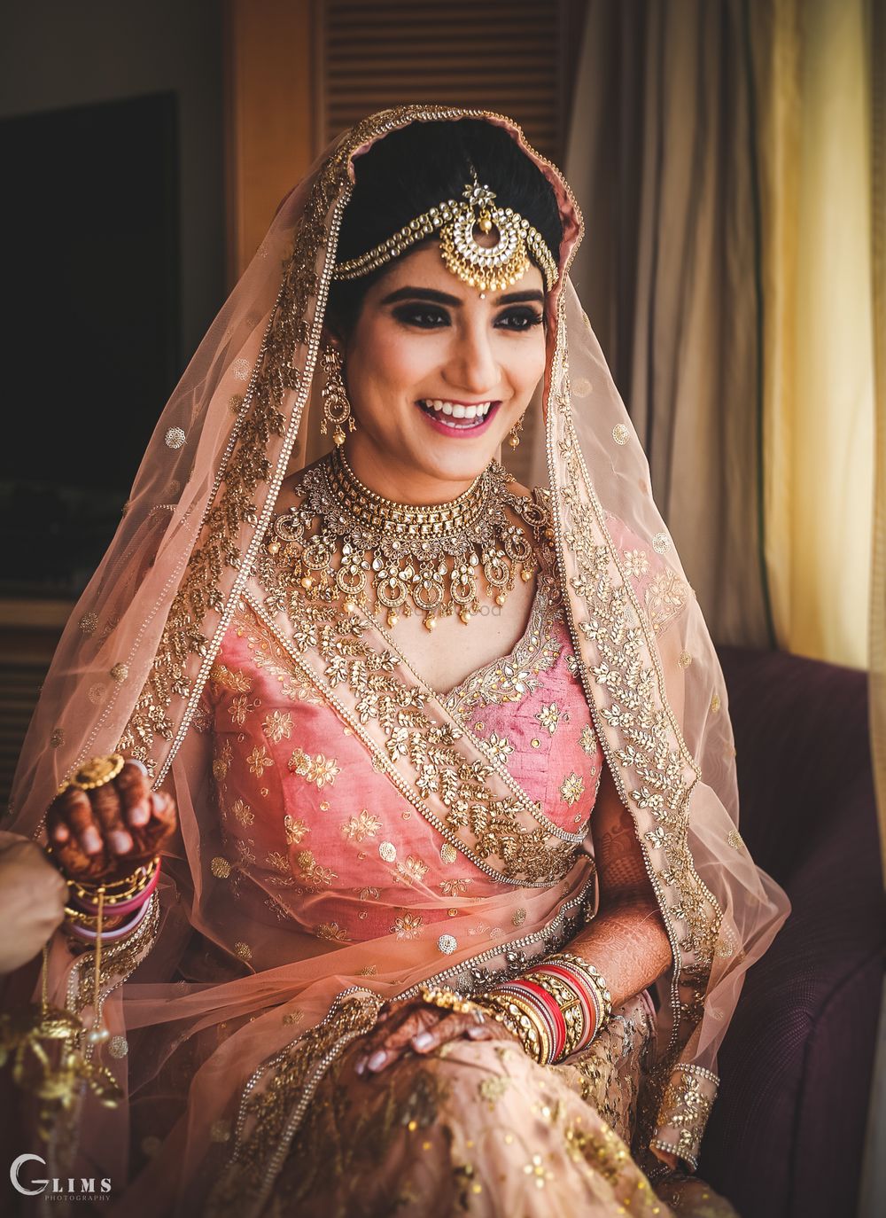 Photo of Bride in peach with statement bridal jewellery