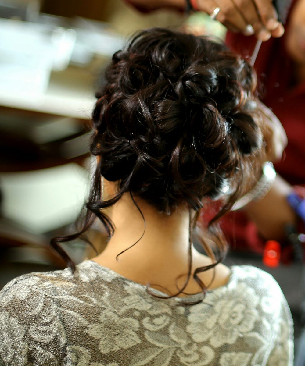 Photo of Engagement hairstyle bun with loose curls