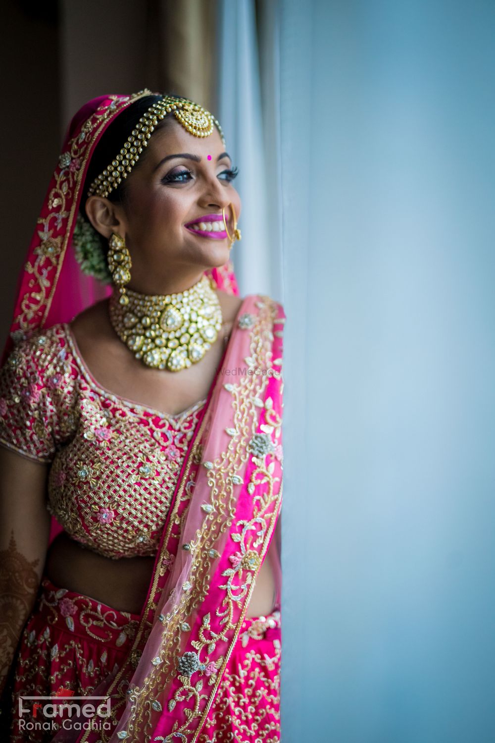 Photo of Happy bride in bright pink lehenga