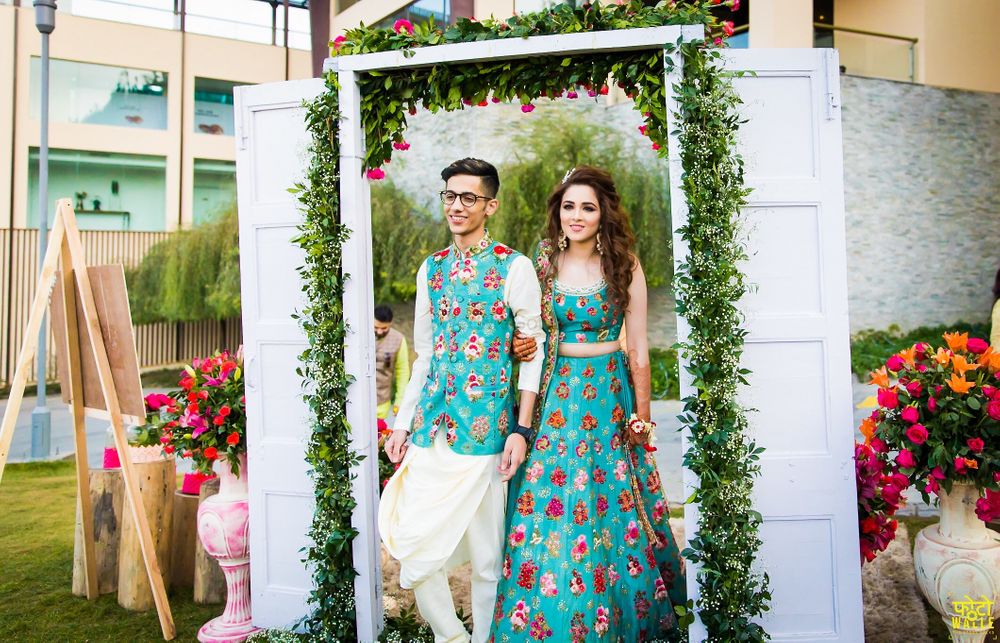 Photo of Matching bride and groom wearing same fabric on mehendi
