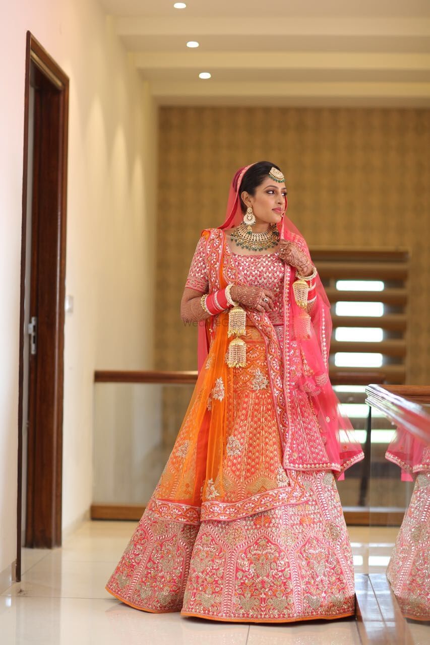 Photo of Orange and pink bridal lehenga with net dupatta