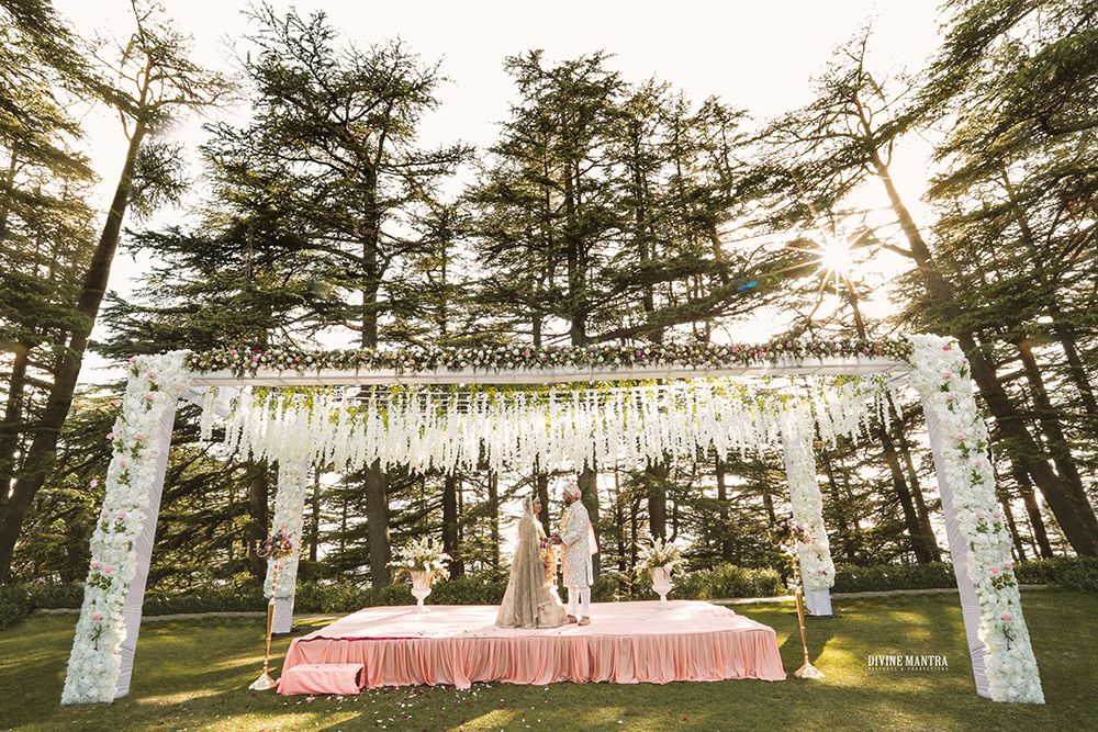 Photo of Forest wedding setting with open pastel mandap