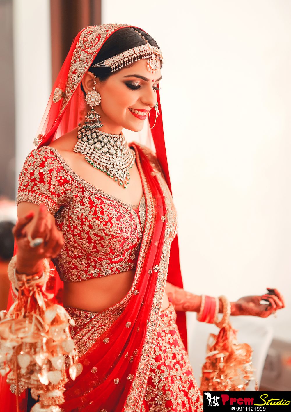 Photo of Bride in red with a handful of kaleere
