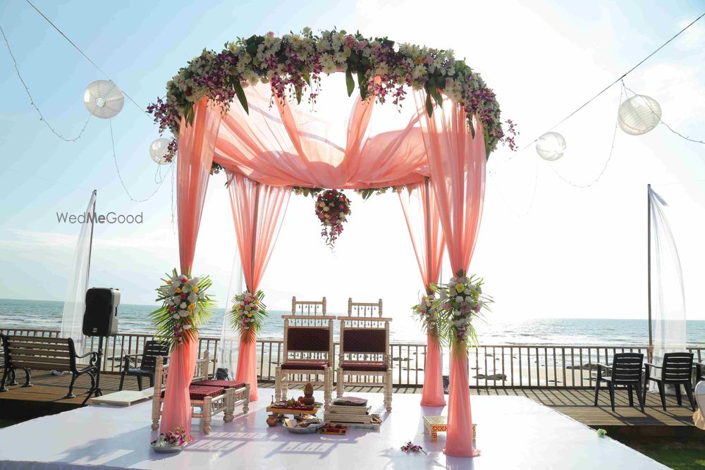 Photo of Round mandap with pastel drapes and florals