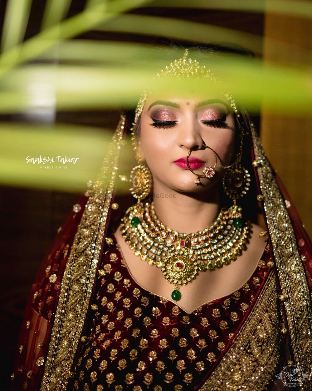 Photo of A bride in maroon lehenga and gold jewellery