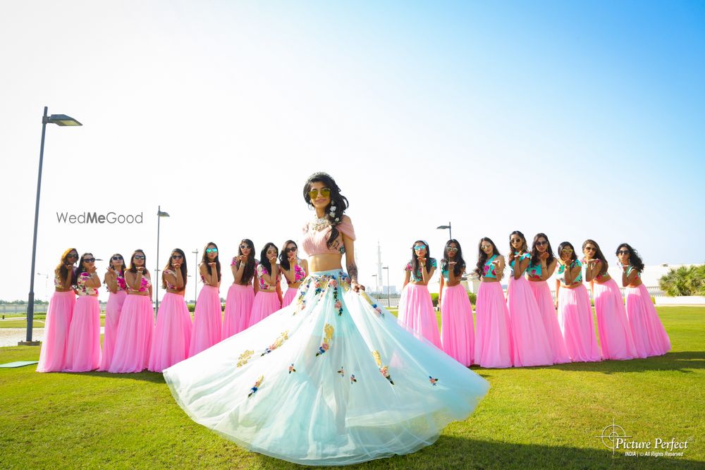 Photo of Matching bridesmaids and twirling bride