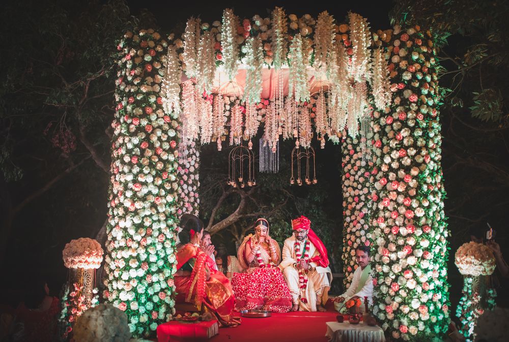 Photo of Floral mandap with hanging floral chandelier