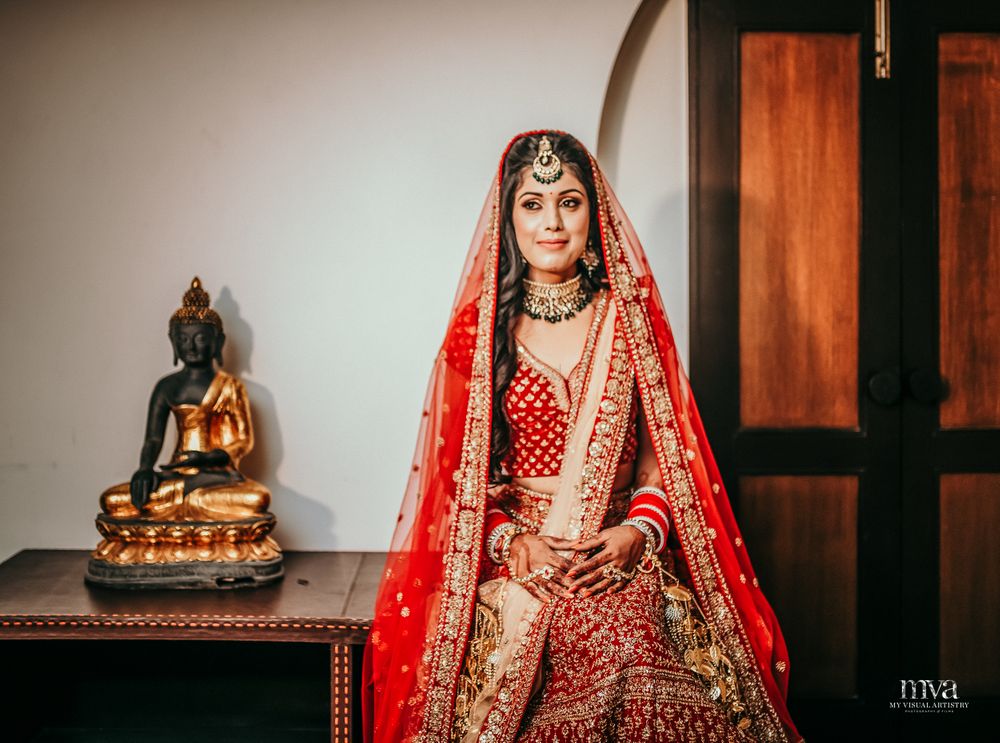 Photo of A bride in a classic red lehenga