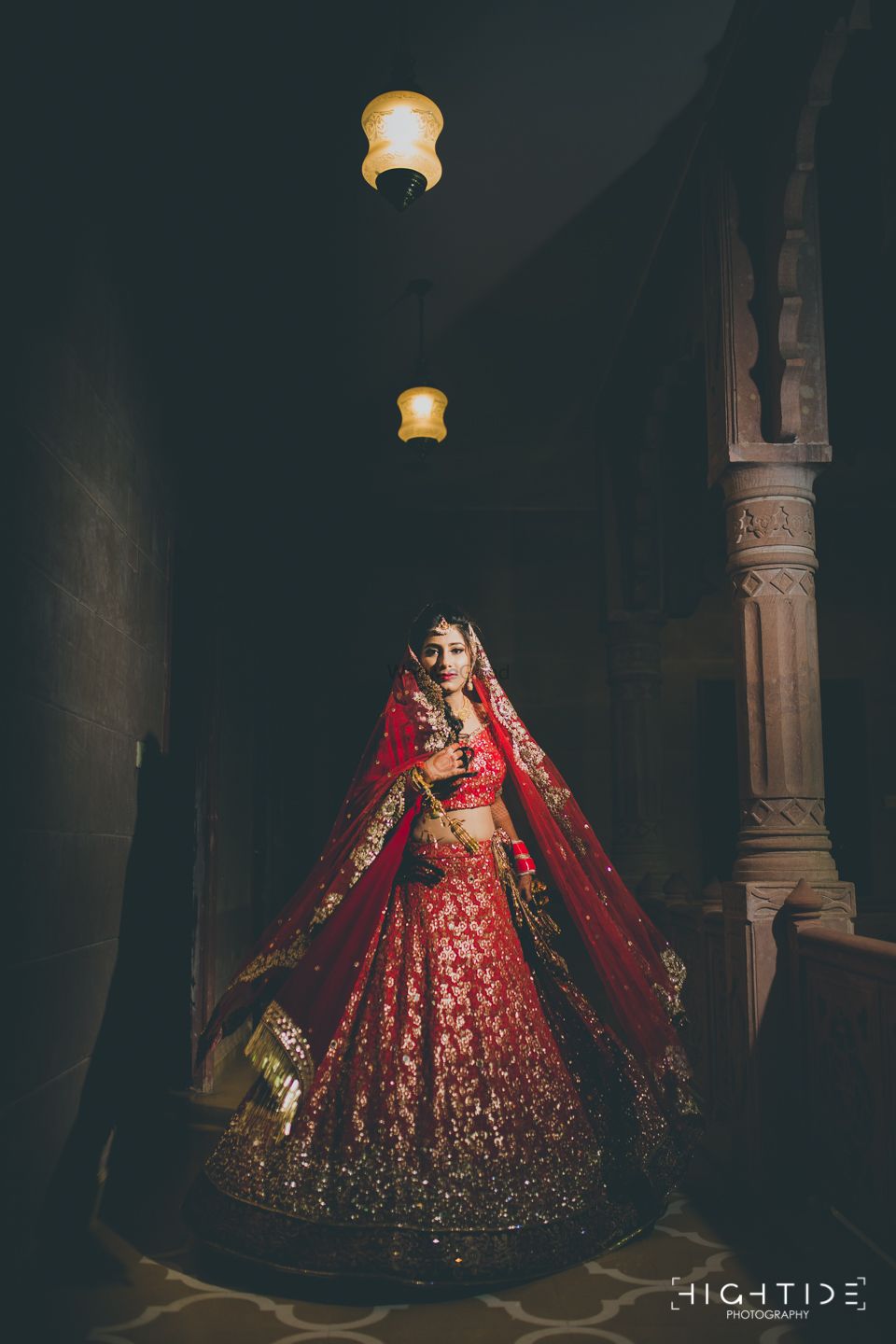 Photo of Twirling bride in red and gold sequin work lehenga