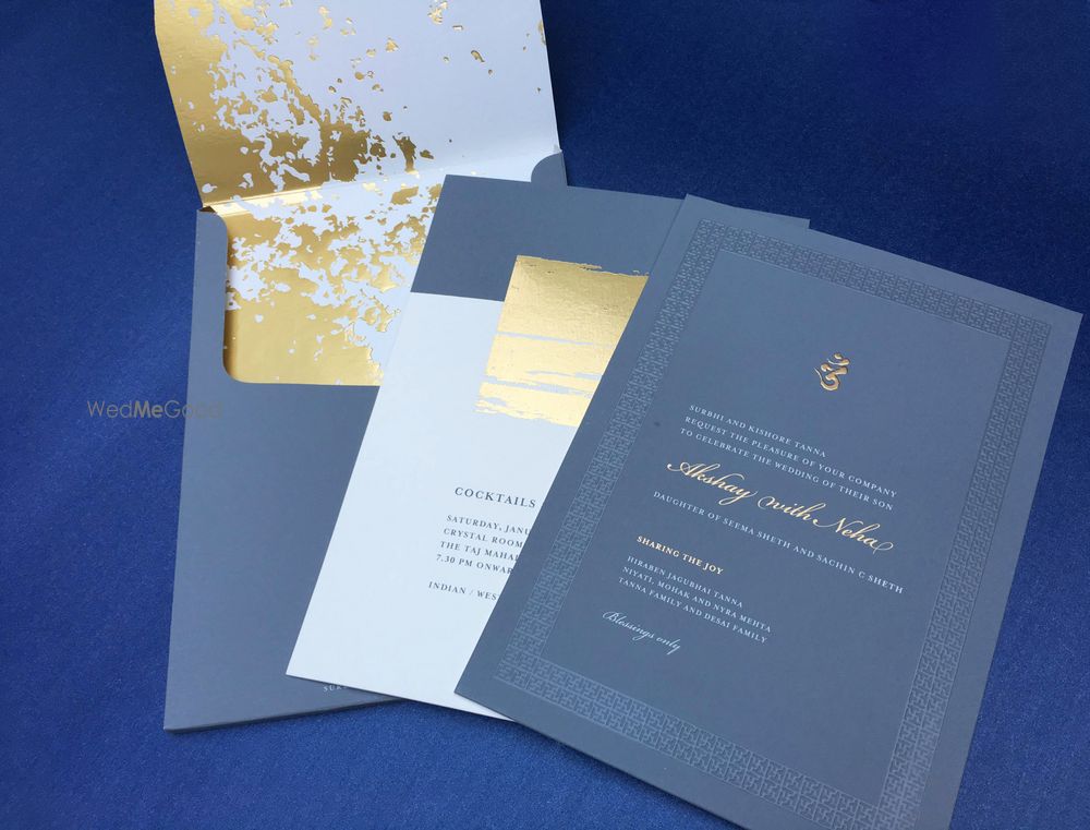 Photo of blue and gold wedding card