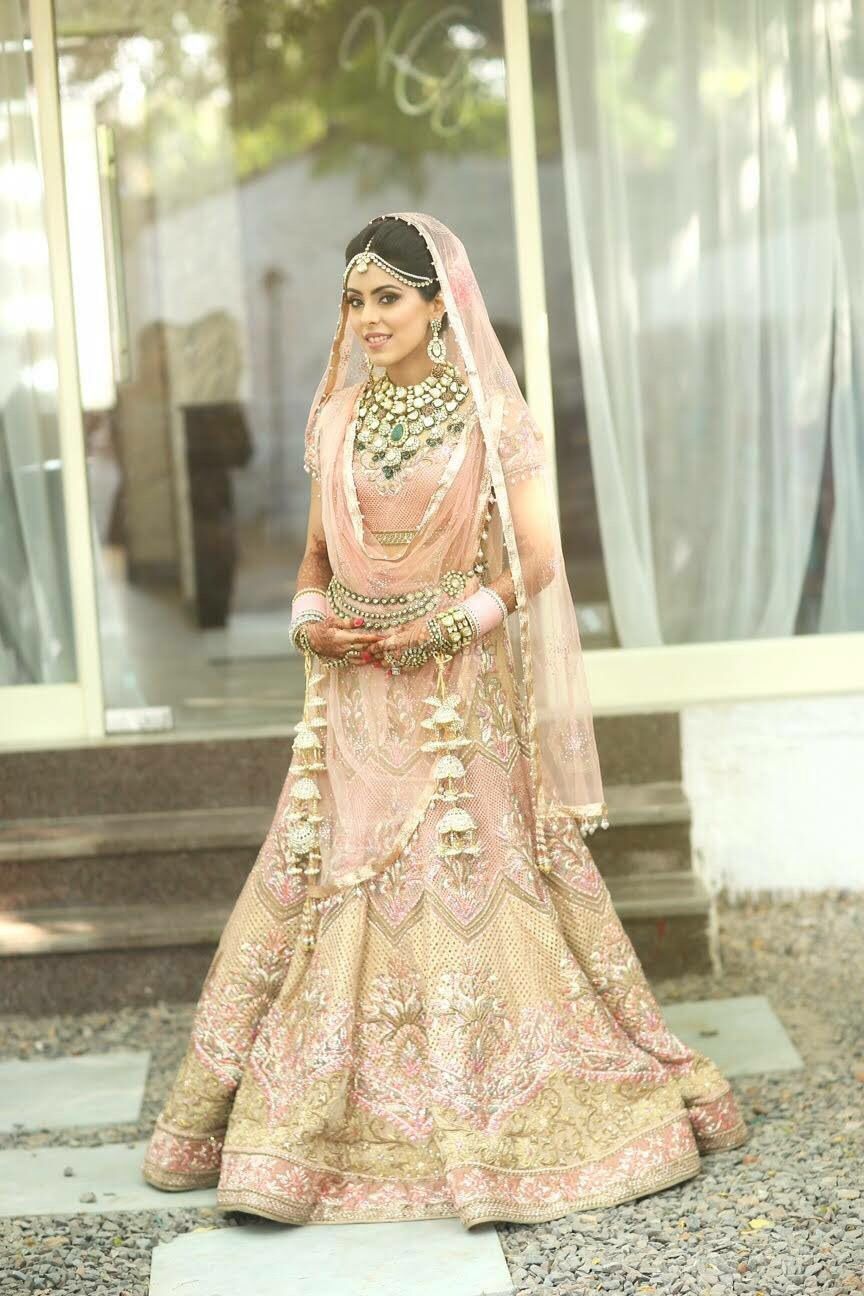Photo of Pastel Peach Lehenga with Gold Work and Emerald Jewelry