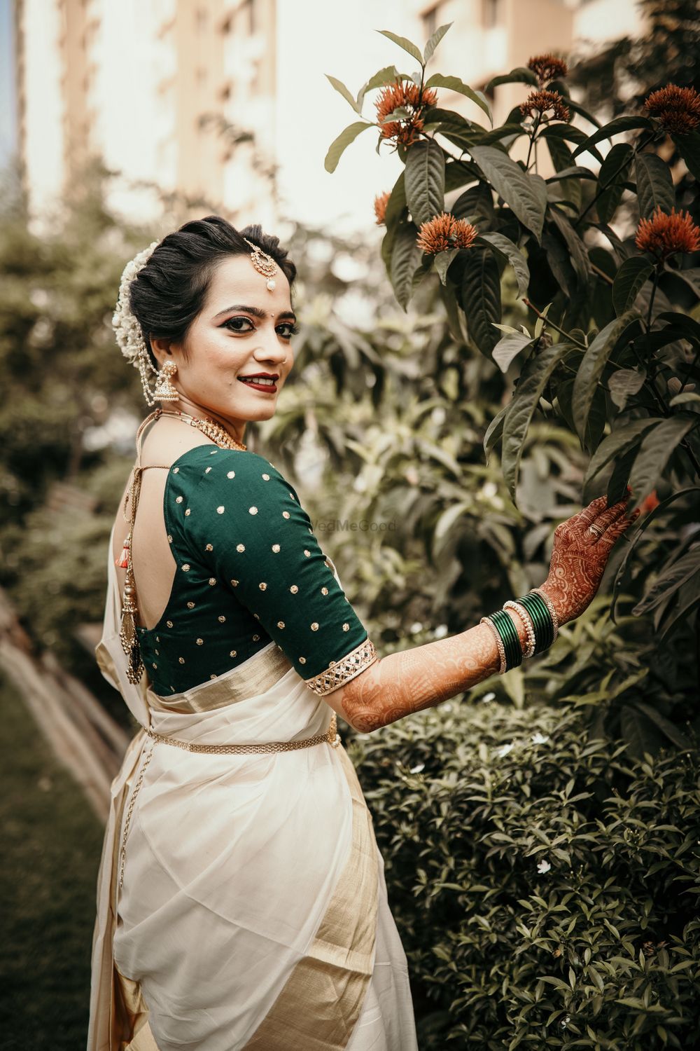 Photo of South Indian bridal look with green blouse and off white saree