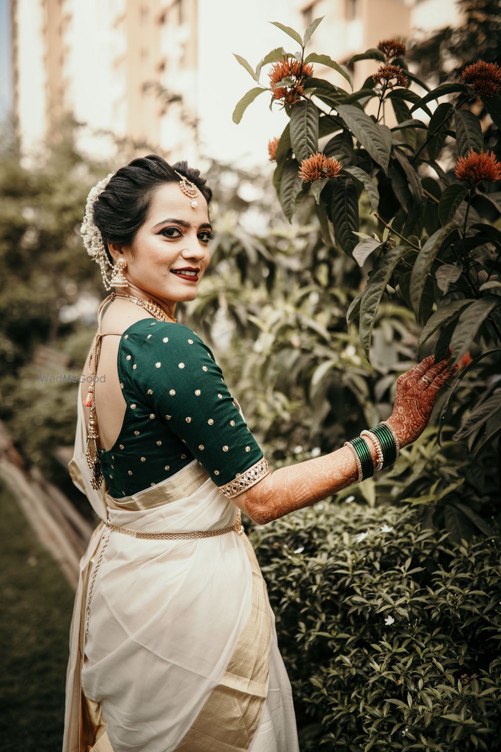 Photo of South Indian bridal look with green blouse and off white saree