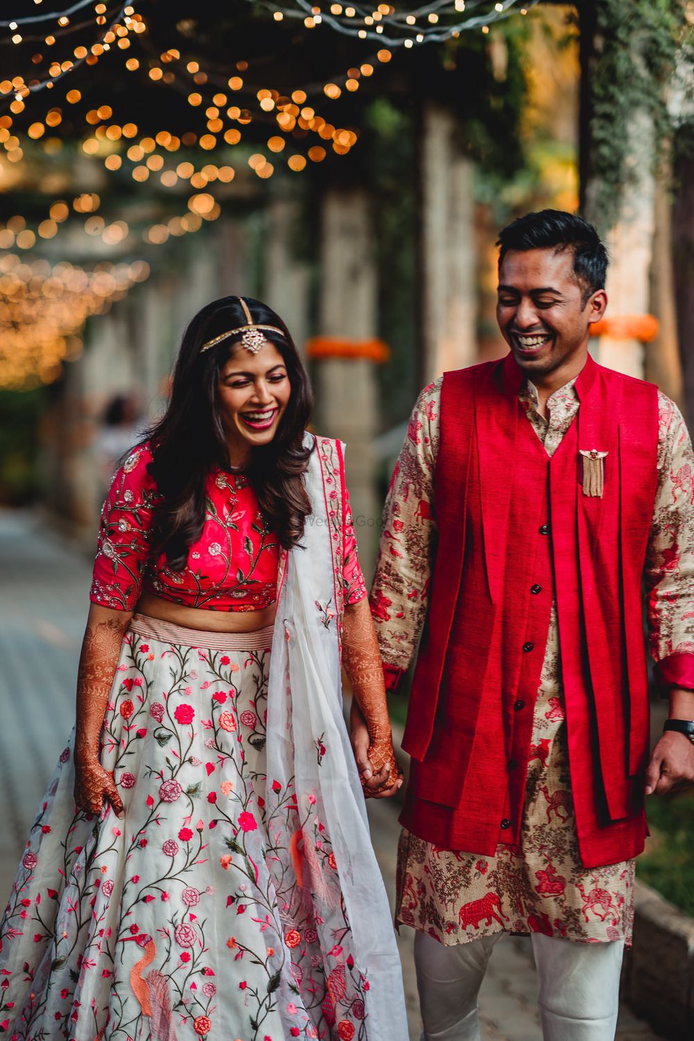 Photo of Matching bride and groom in red on mehendi