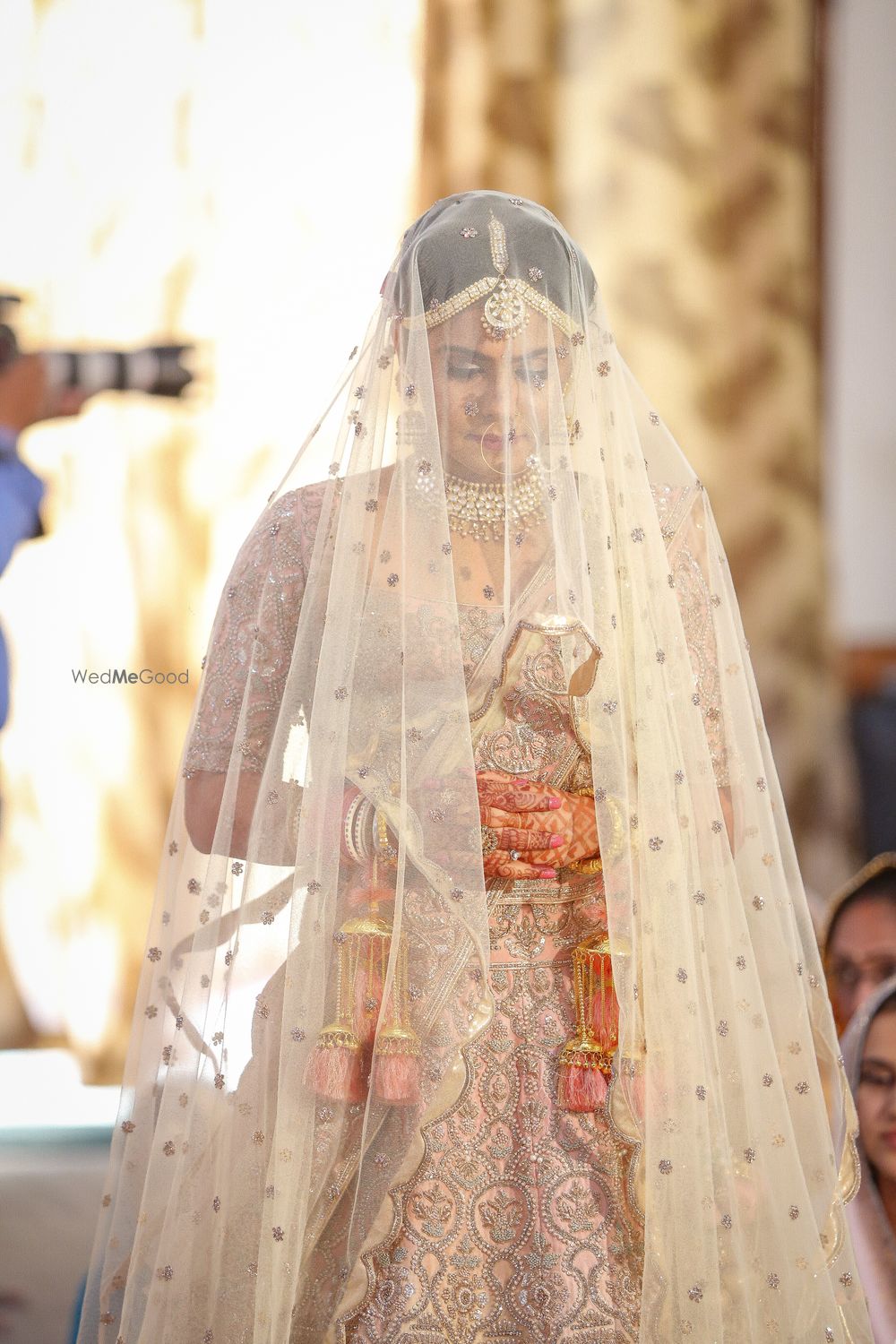 Photo of Sikh bride entering wearing veil