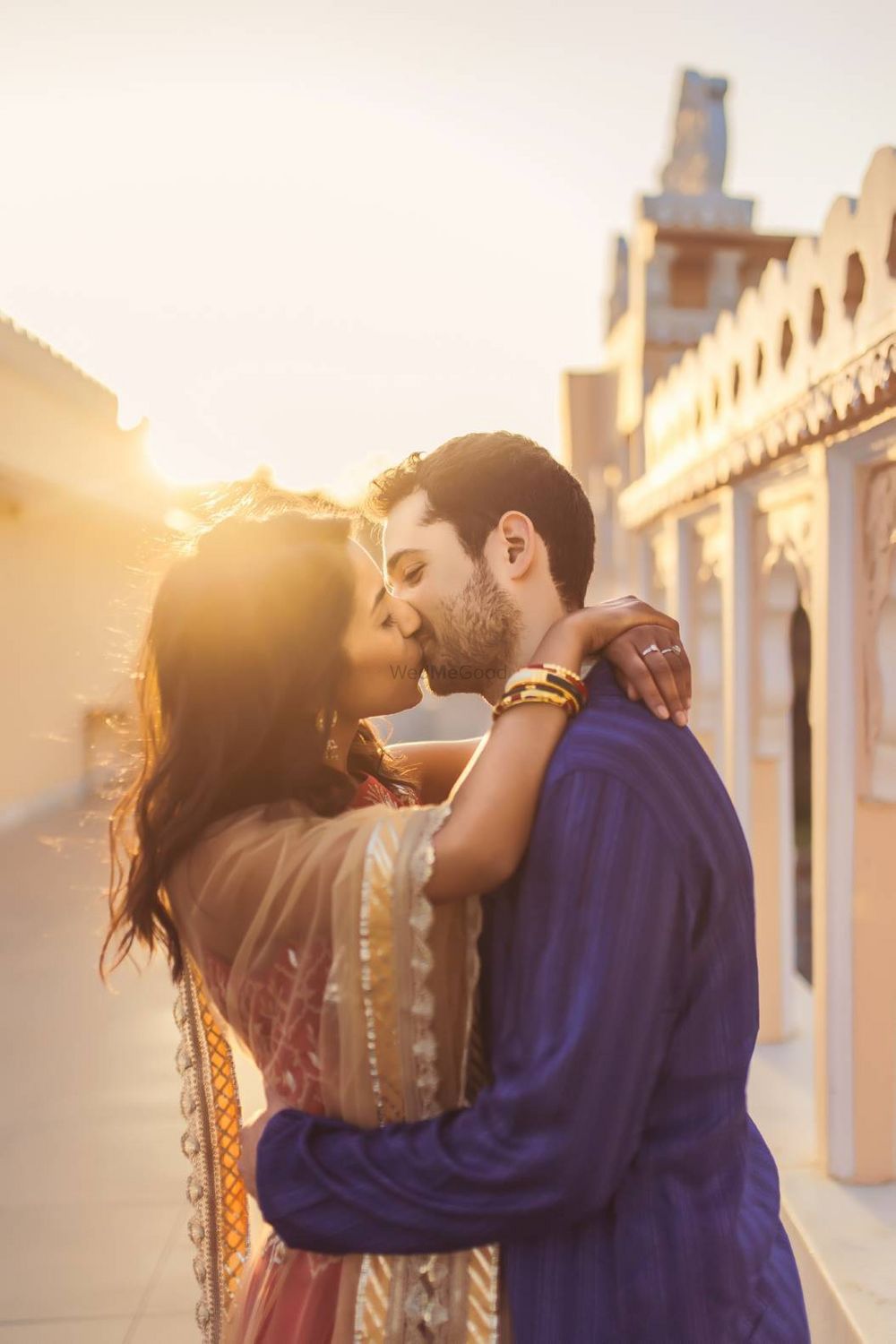 Photo of Couple kissing pre wedding shot