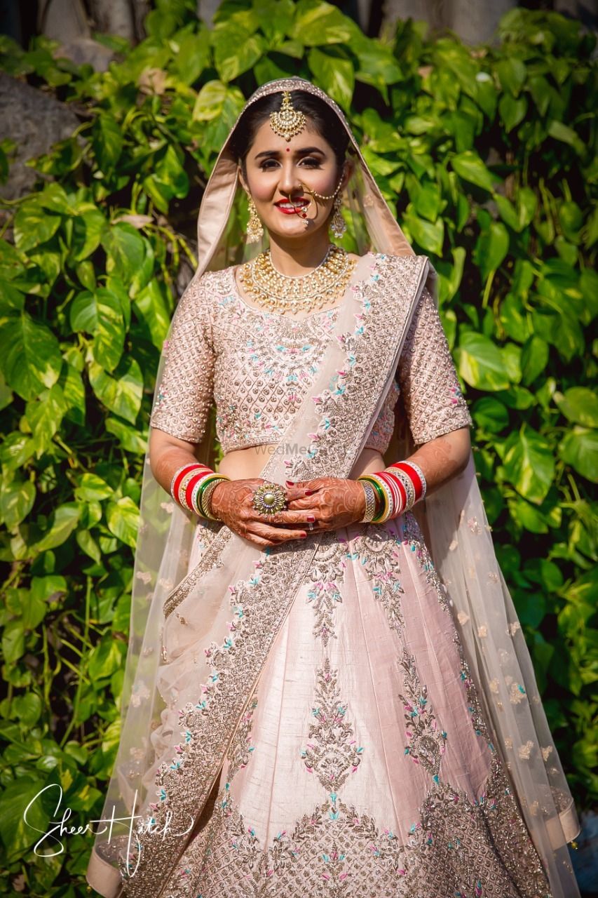 Photo of Blush pink bridal lehenga with blue work