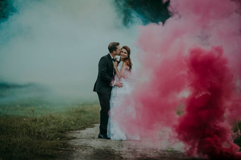 Photo of Couple portrait with smoke sticks post wedding