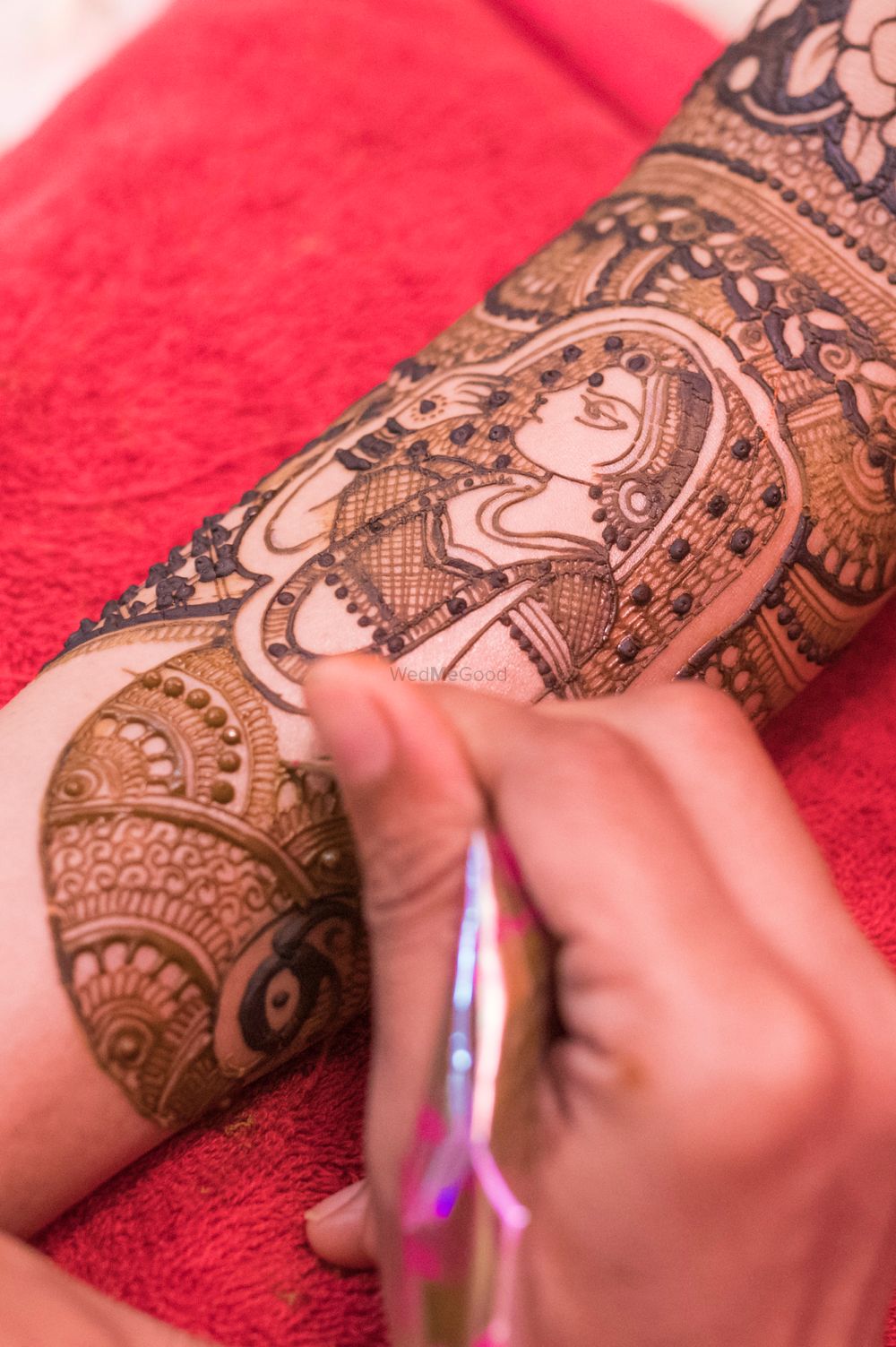 Photo of Mehendi design on arm with bridal portrait