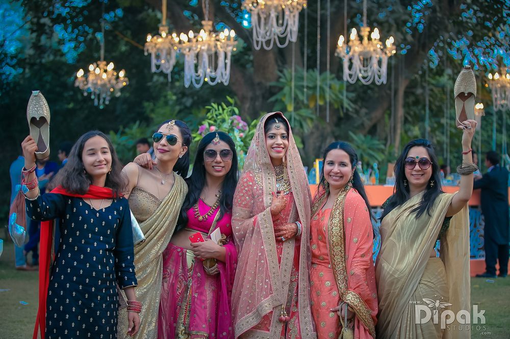 Photo of Outdoor dusk wedding with bride and bridesmaids Indian