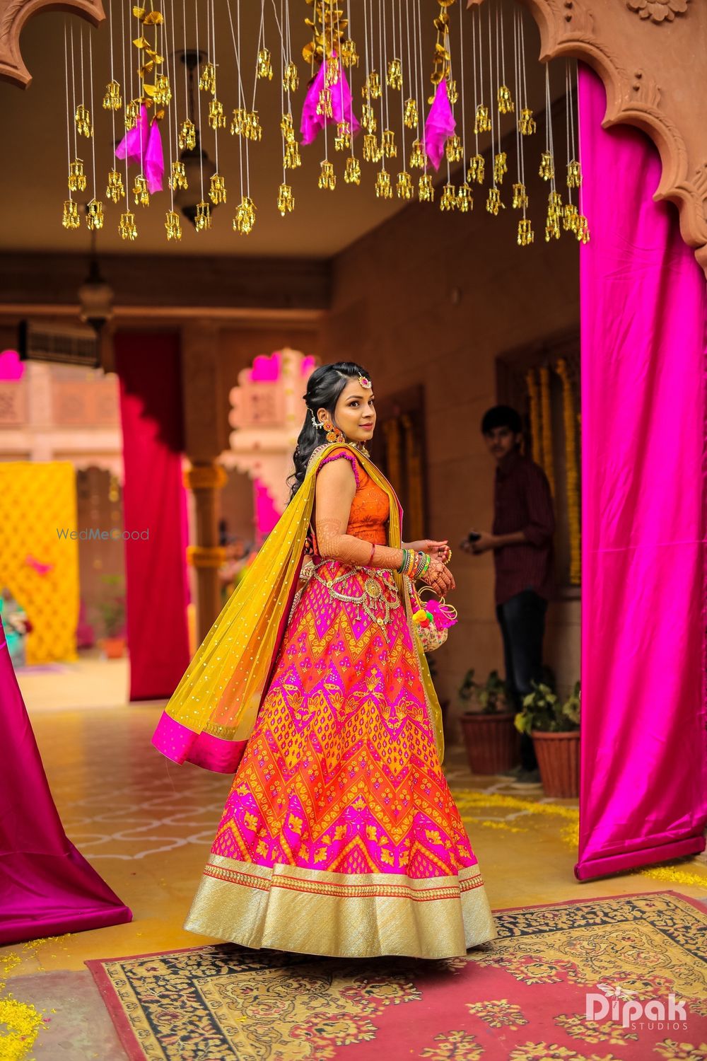 Photo of Orange and pink zig zag print mehendi lehenga