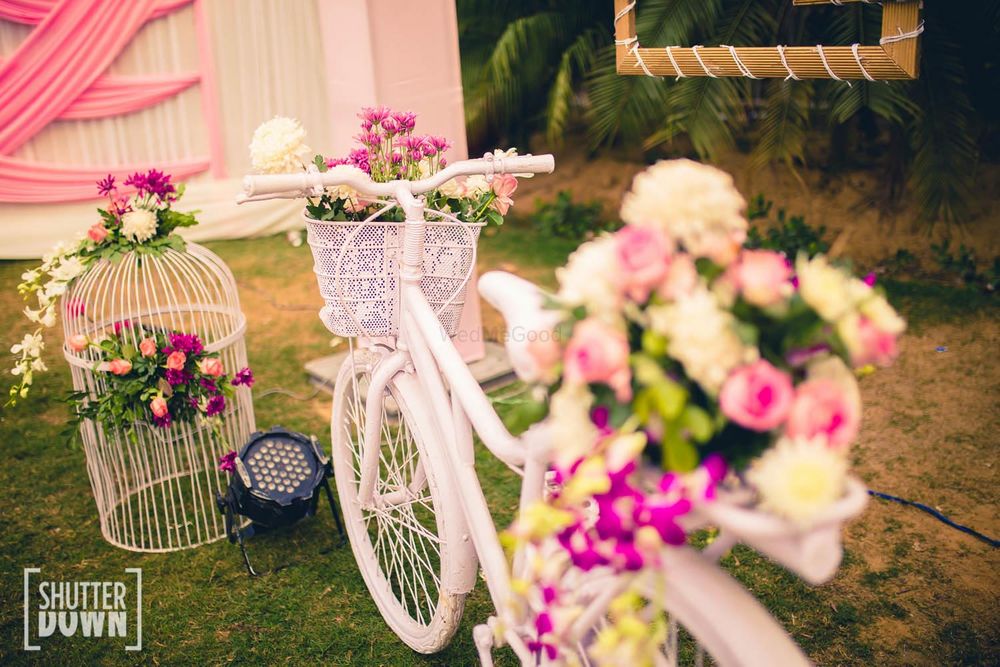 Photo of white bicycle prop in wedding decor