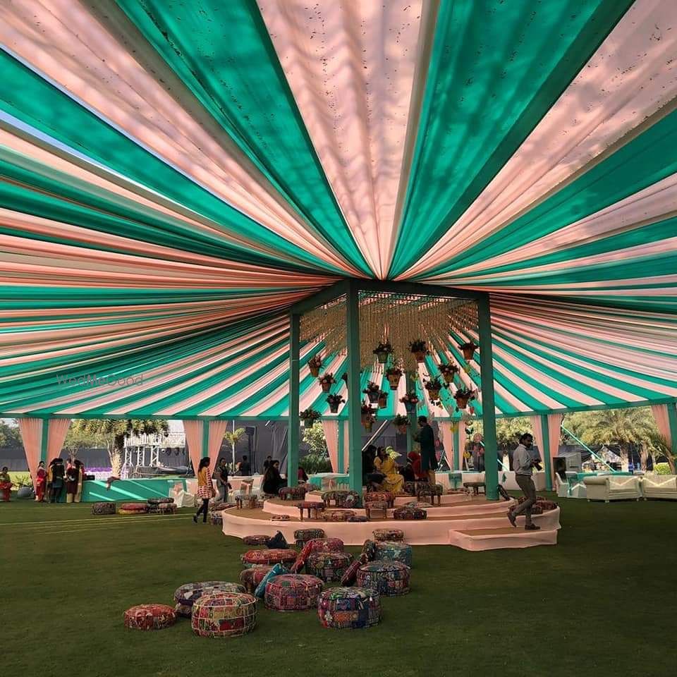 Photo of A pink and green tent decor at a day wedding