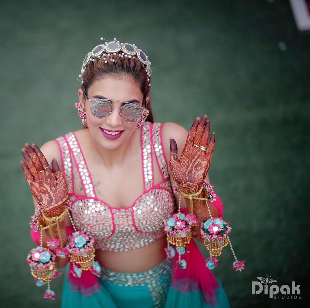 Photo of Bride on mehendi wearing floral kaleere