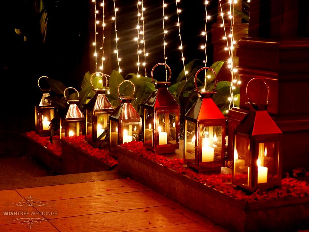Photo of Gold Lanterns with Dim Candles and Fairy Lights Decor