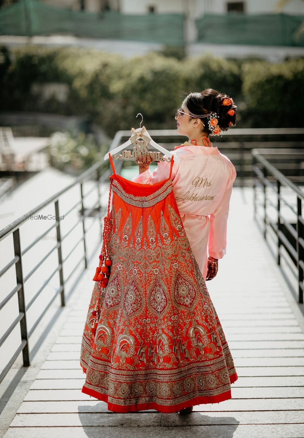 Photo of Outdoor bridal shoot holding lehenga