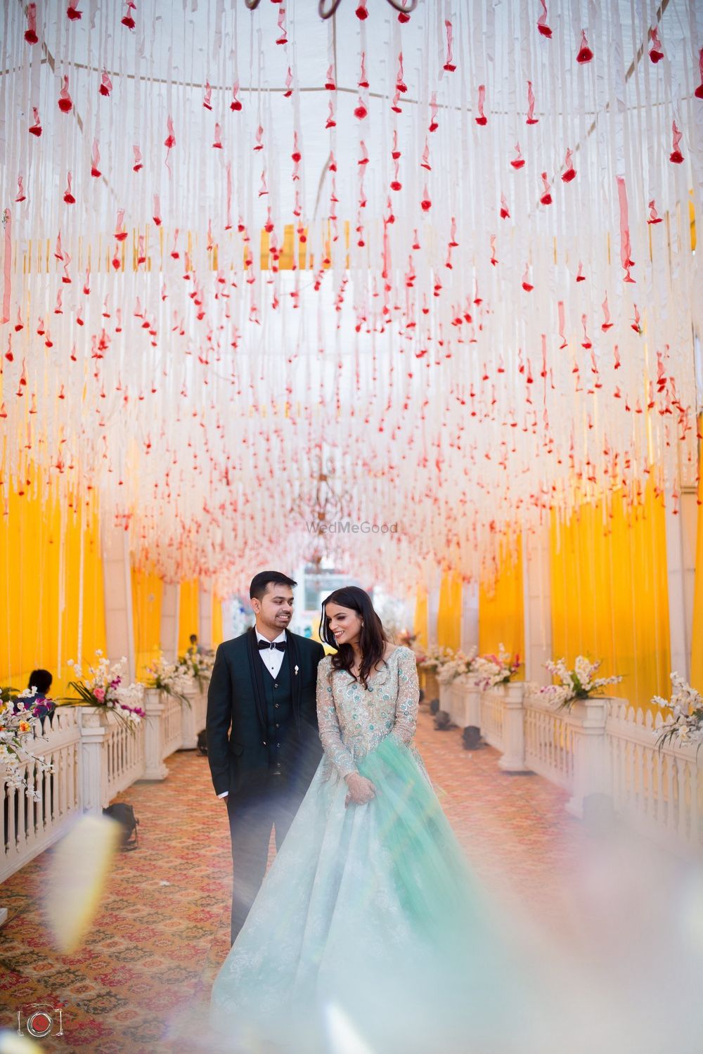 Photo of Engagement or sangeet couple shot with floral string decor