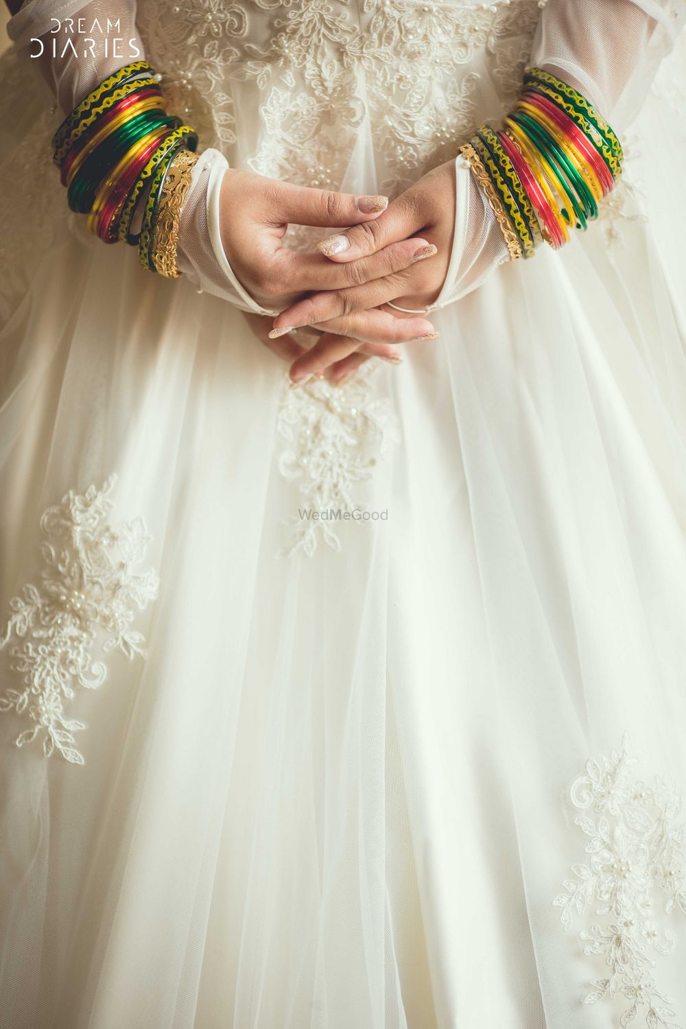 Photo of Green and yellow bangles over white gown