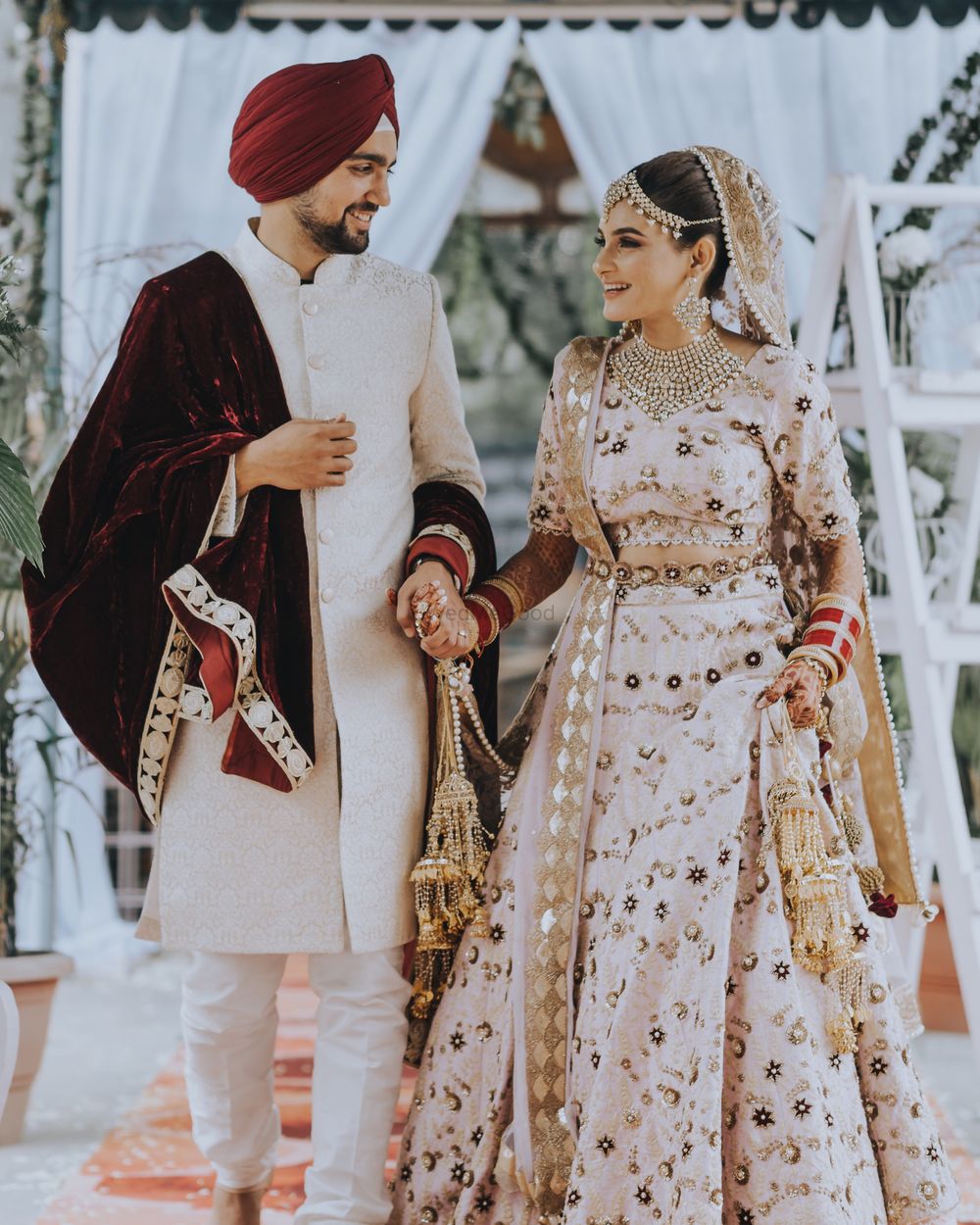 Photo of Matching bride and groom in beige with velvet stole