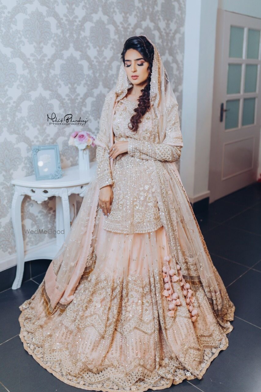 Photo of peach bridal lehenga with peplum blouse