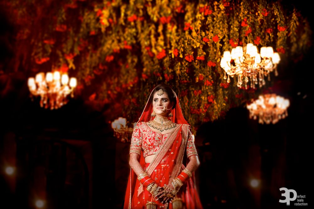 Photo of Bridal portrait low angle shot in red sabya lehenga