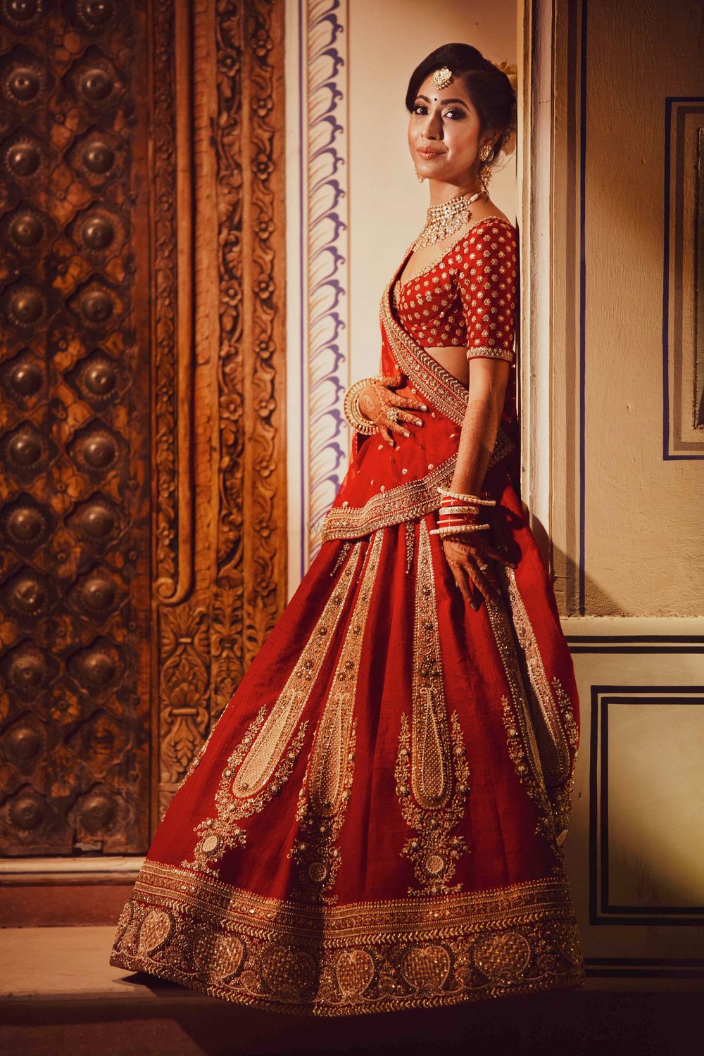 Photo of Minimal bridal lehenga with red and gold work