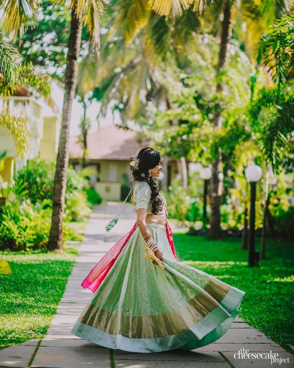 Photo of A bride twirling in her pastel green lehenga.