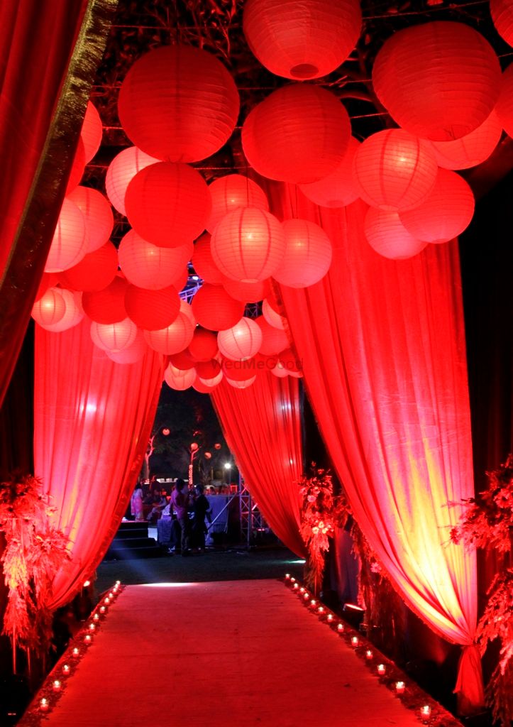 Photo of Red lamps at entrance way hanging lamps from the ceiling with drapes and red