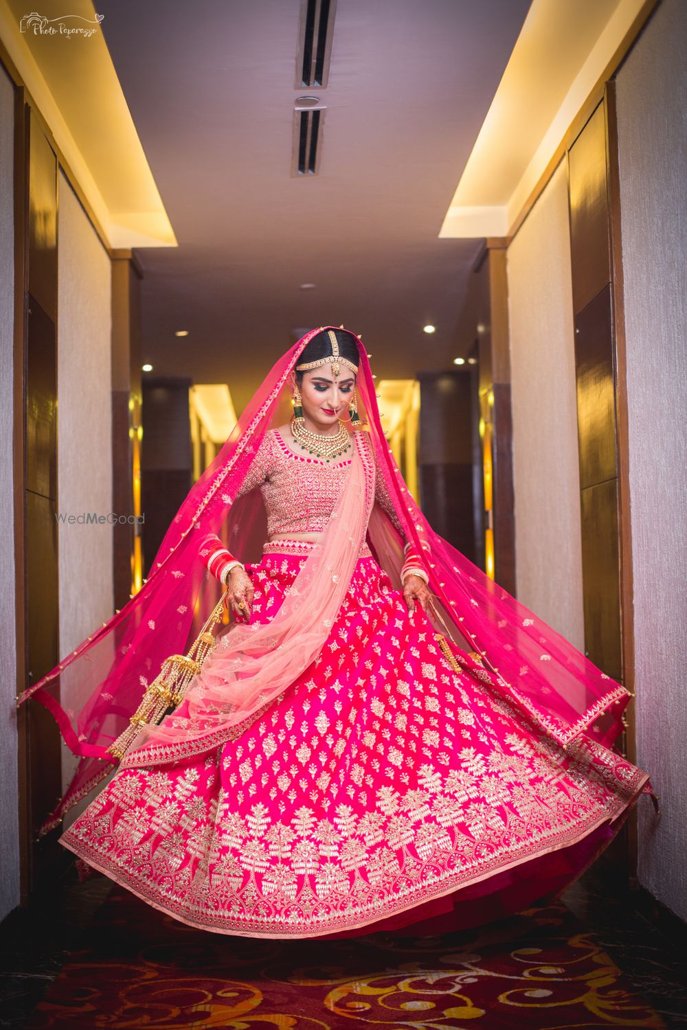 Photo of Bright showing off her bright pink gota patti lehenga